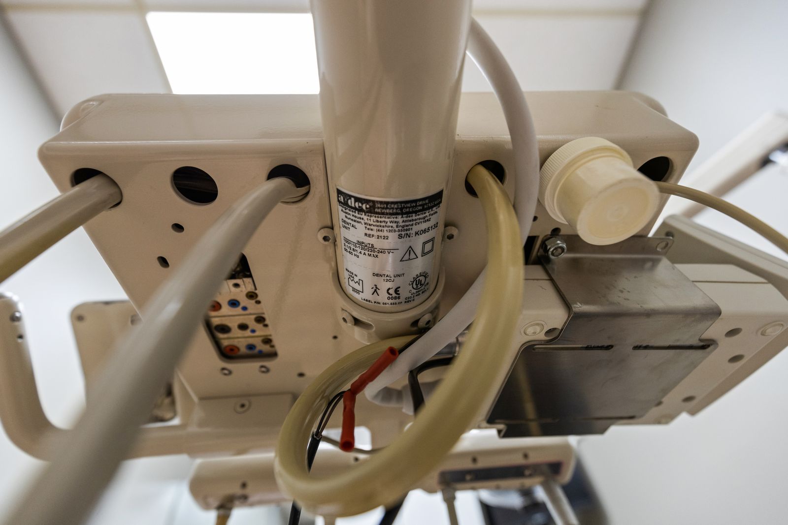 Close-up of an A-dec manufacturer label showing the serial number and build year