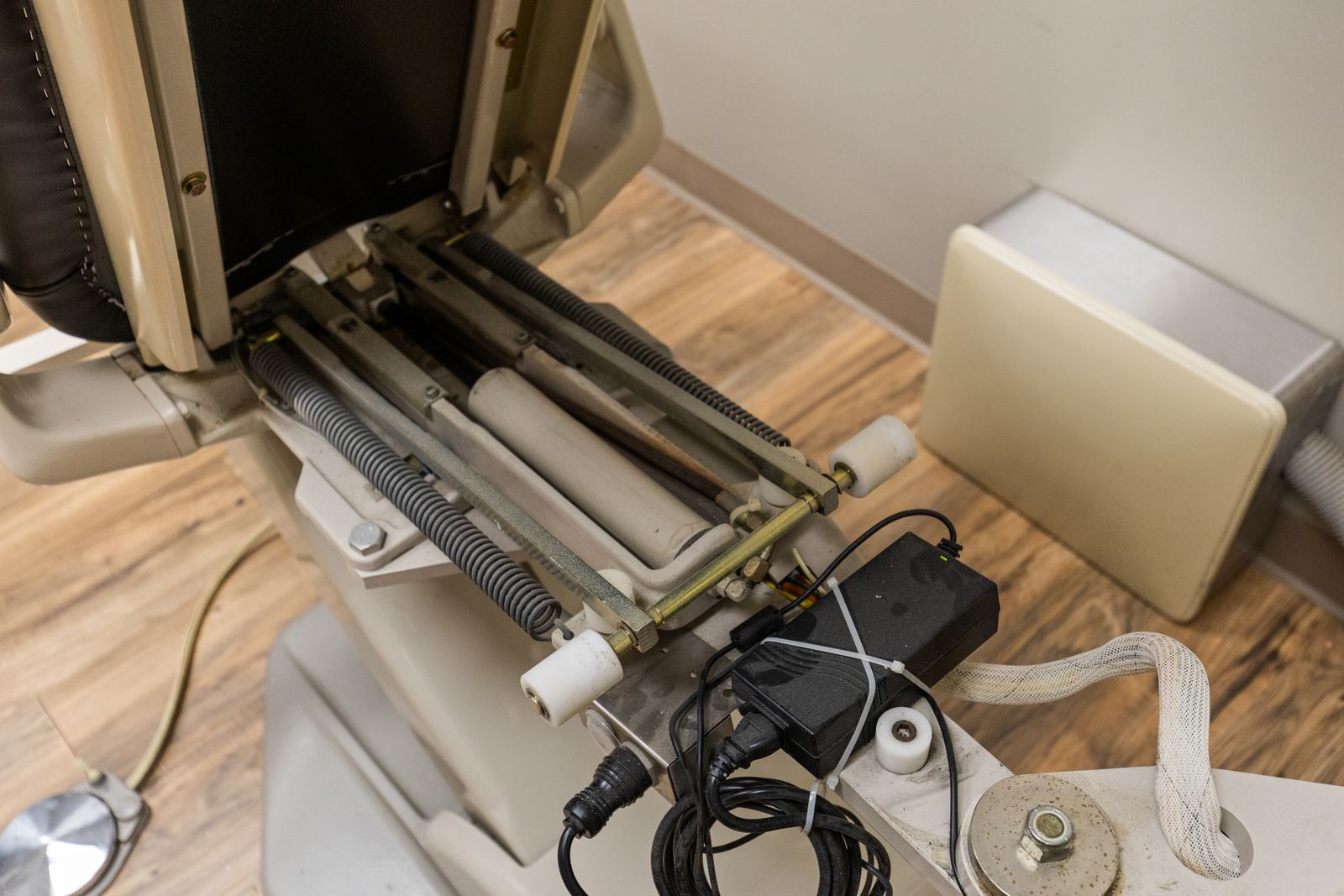 Exposed dental chair base with the cover removed, shown as disclosed in the listing