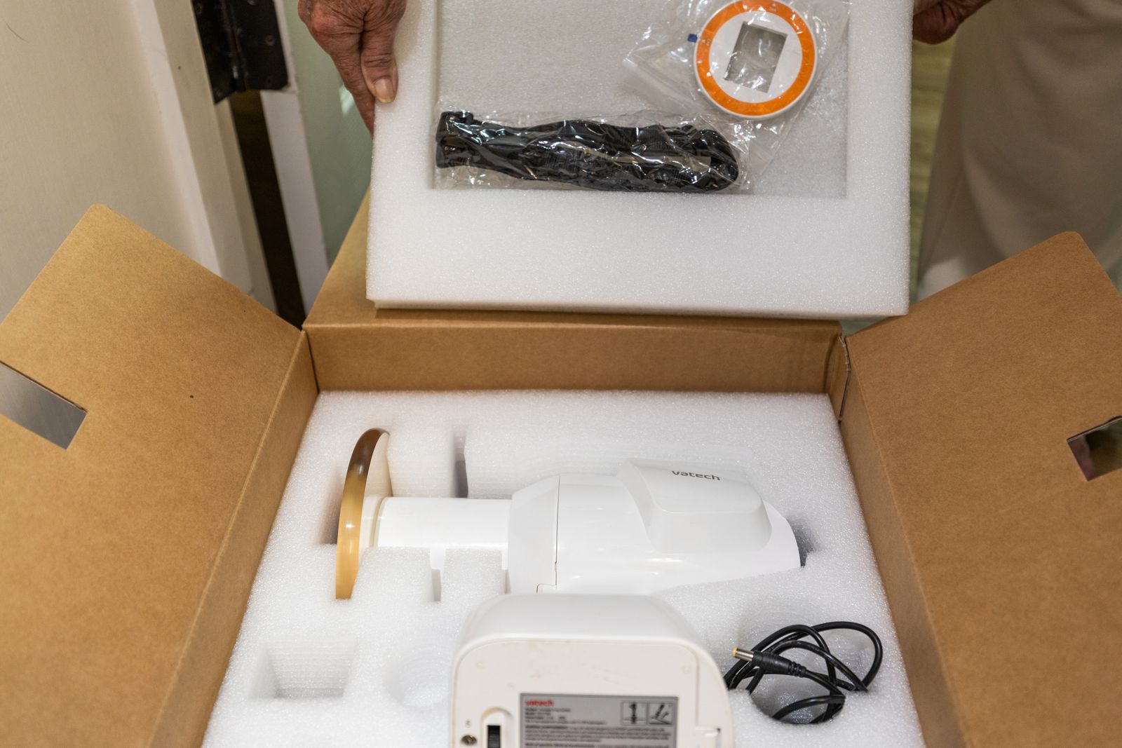 Hands lifting the foam lid off a box of packed dental equipment